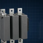 Large CJX2-F industrial contactor on a dark navy blueprint grid with faint battery cell silhouettes